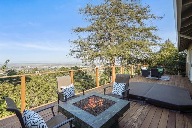 a view of a balcony with two chairs and a table