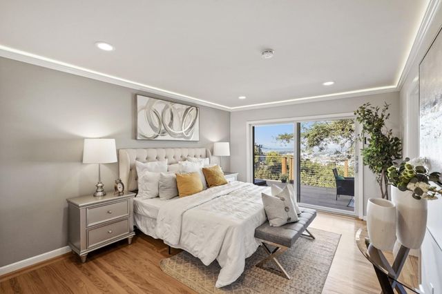a bedroom with a large bed and a chandelier