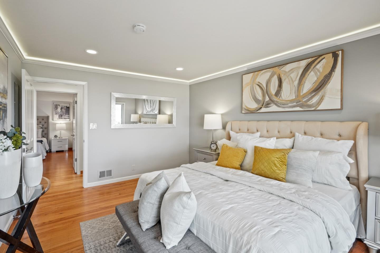 22 Del Rey Court San Carlos, CA 94070 - Photo 16 of 47 a bedroom with a large bed and a chandelier