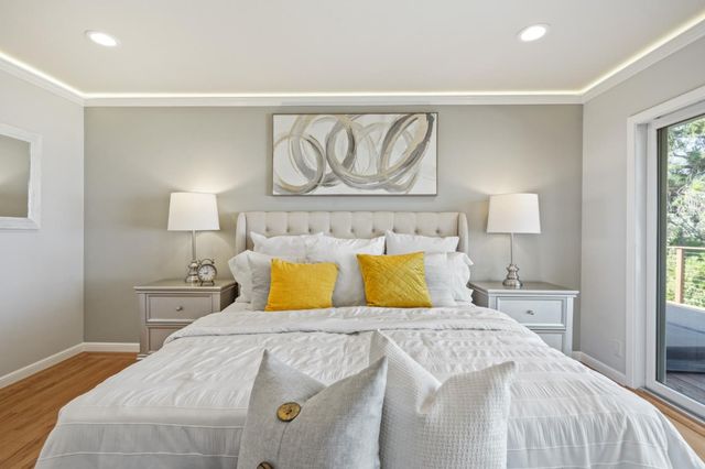 a bathroom with double vanity sink a two mirror a window and a toilet