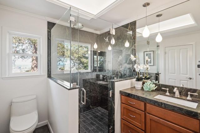a spacious bathroom with a granite countertop sink mirror and a shower
