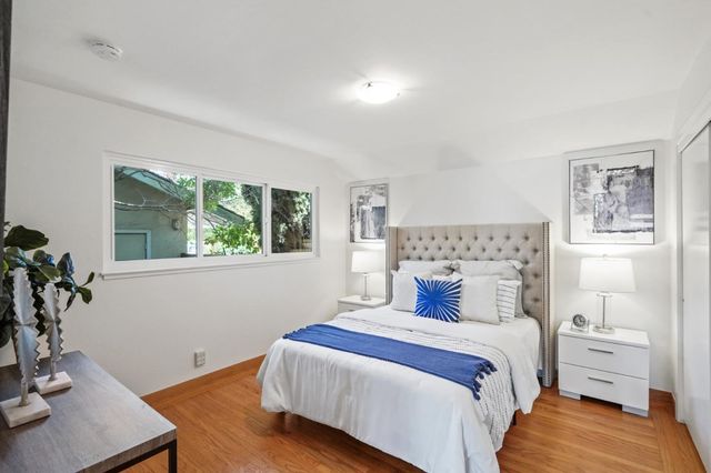 a bedroom with a bed and a night stand