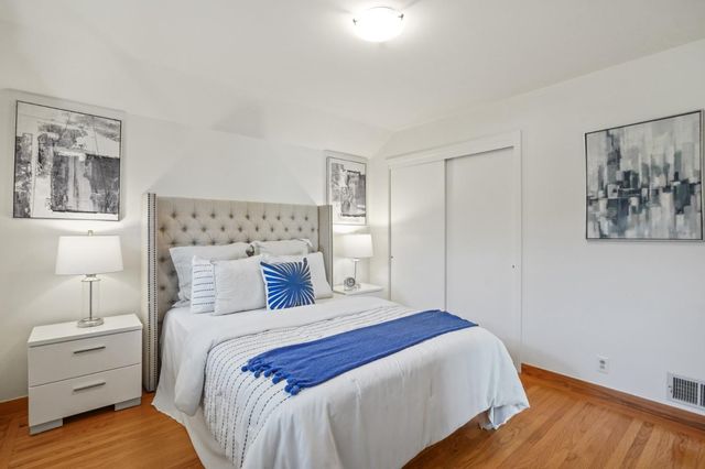 a bed room with a bed tv and a window