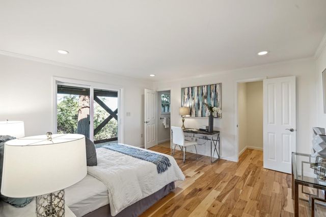 a bedroom with a large bed and a window