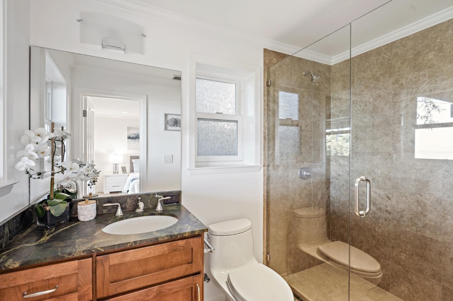 22 Del Rey Court San Carlos, CA 94070 - Photo 35 of 47 a bathroom with a granite countertop toilet sink shower and mirror