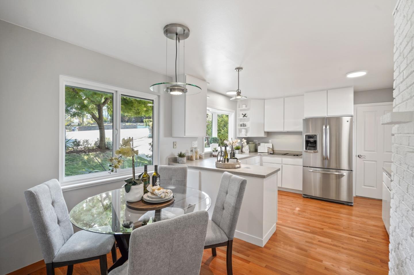22 Del Rey Court San Carlos, CA 94070 - Photo 5 of 47 a kitchen with refrigerator cabinets dining table and chairs