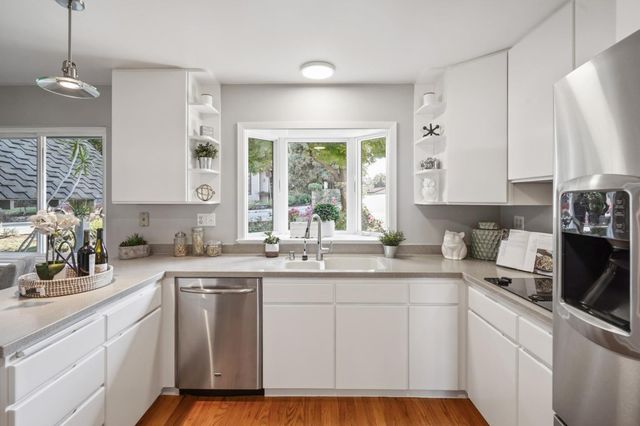 a kitchen with sink cabinets and window