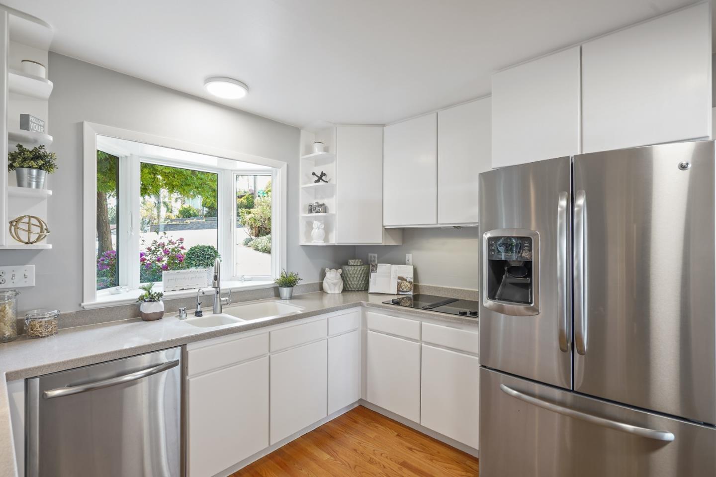 22 Del Rey Court San Carlos, CA 94070 - Photo 9 of 47 a kitchen with a refrigerator a sink cabinets and wooden floor