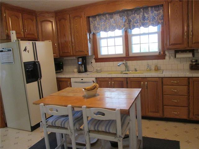 5385 Awalt Road Tullahoma, TN 37388 - Photo 11 of 20 Kitchen with lots of updates. Lots of oak cabinets, new bosch dishwasher, newer convection oven, eat in, refrigerator, and tile countertops