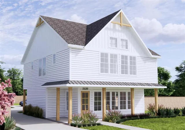 a view of a white house next to a yard