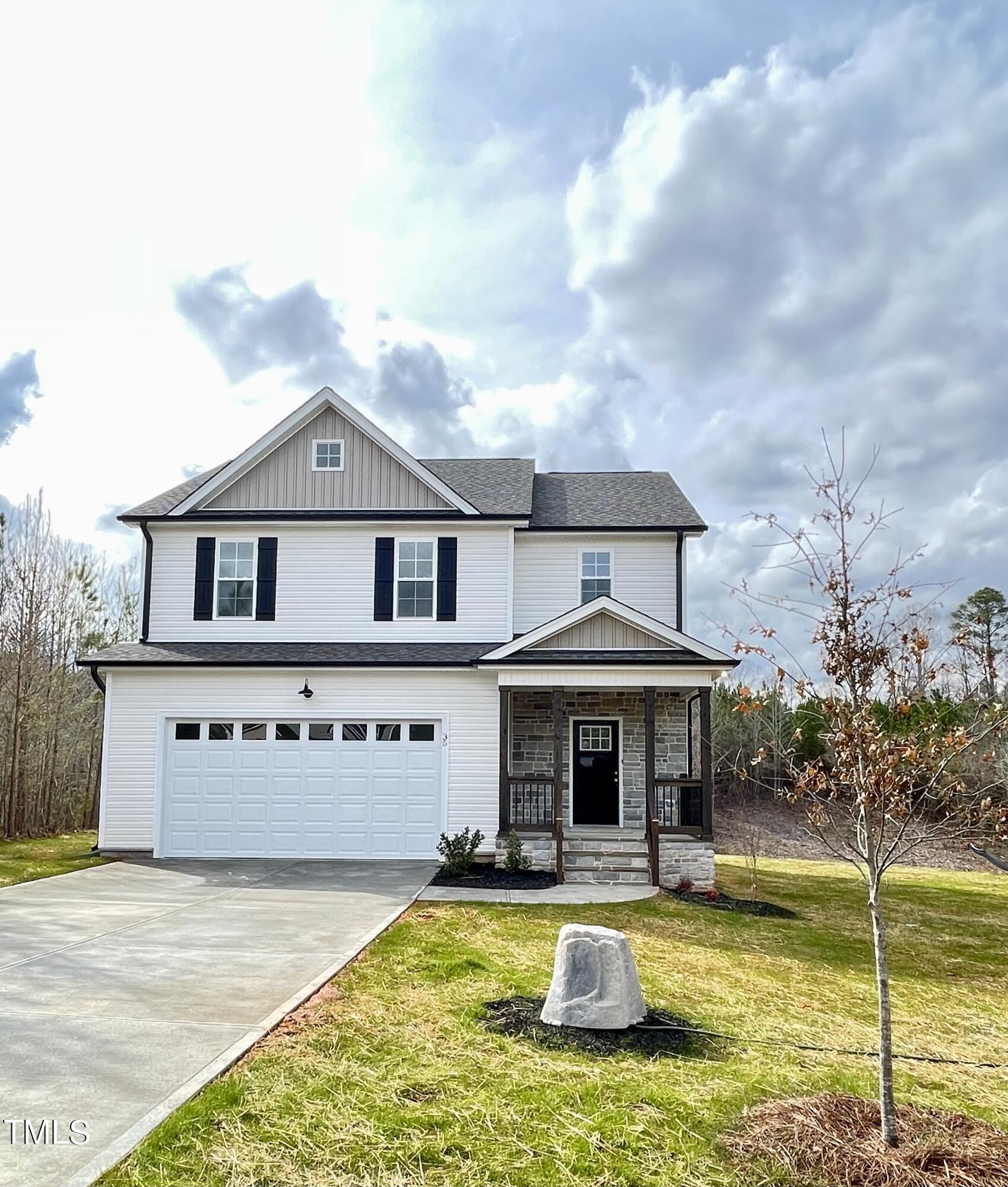 a front view of a house with swimming pool having outdoor seating
