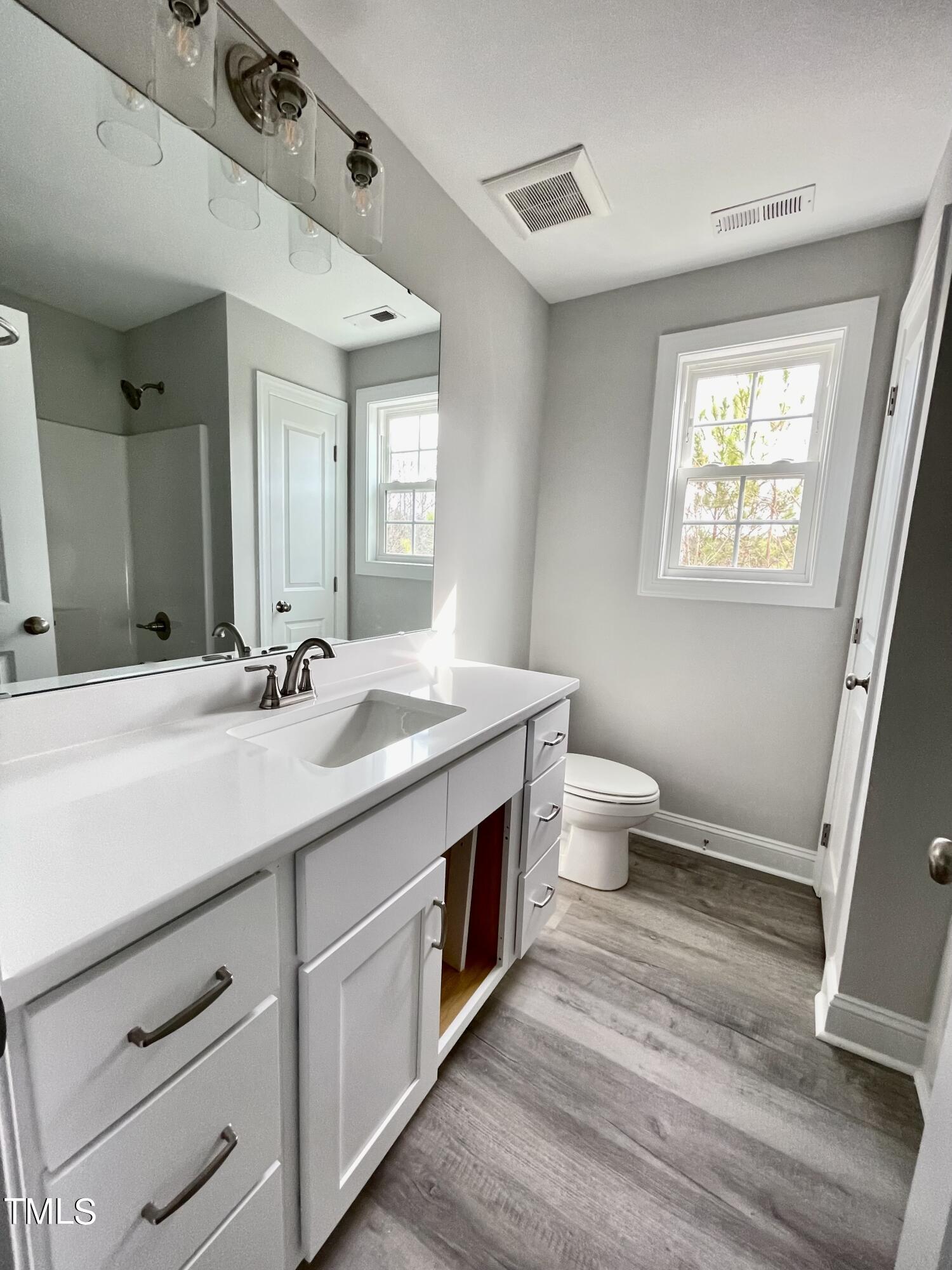 35 Sunrise Court Spring Hope, NC 27882 - Photo 14 of 18 a spacious bathroom with a double vanity sink toilet and a mirror