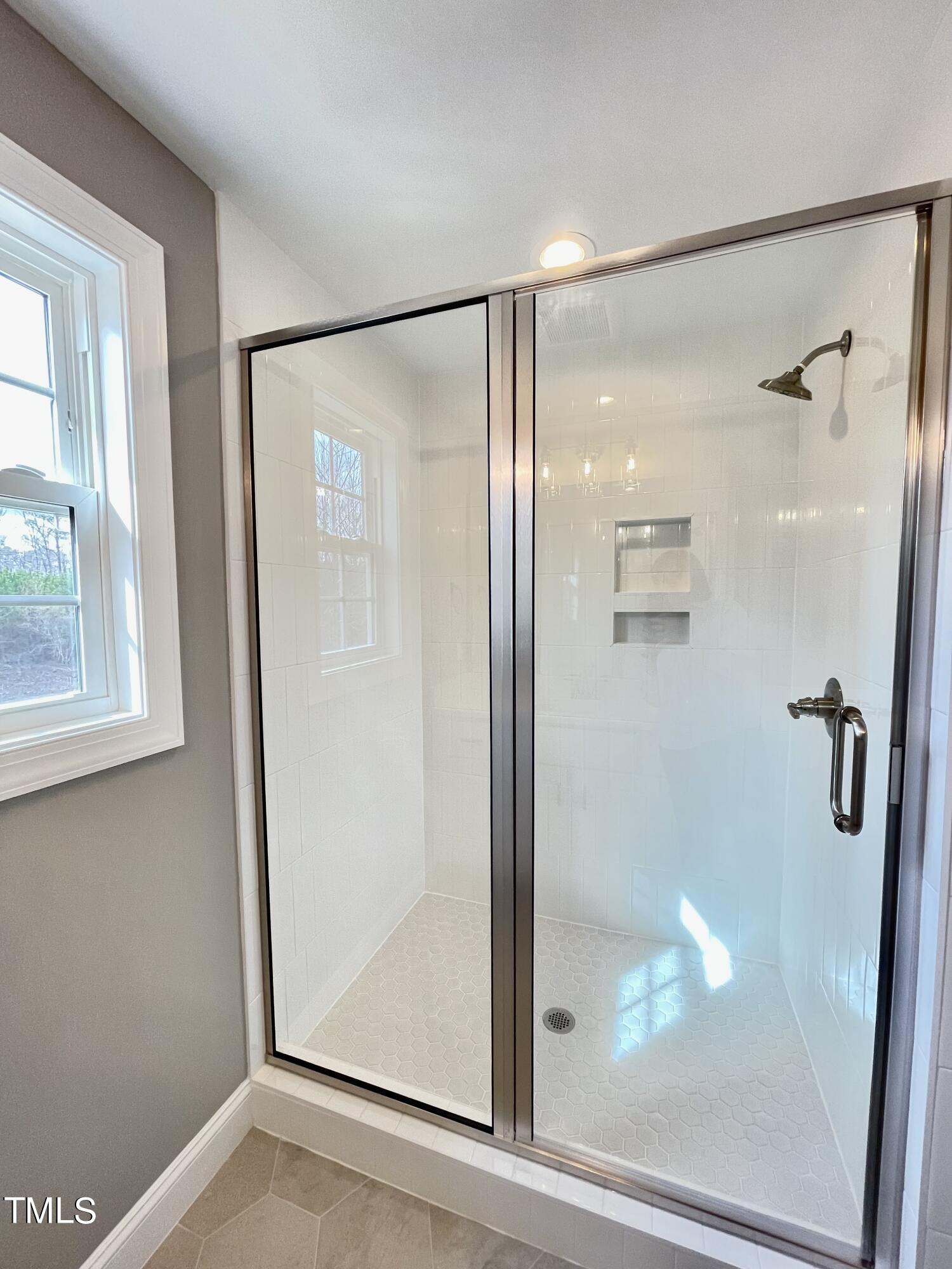 35 Sunrise Court Spring Hope, NC 27882 - Photo 15 of 18 a bathroom with a glass shower door and mirror