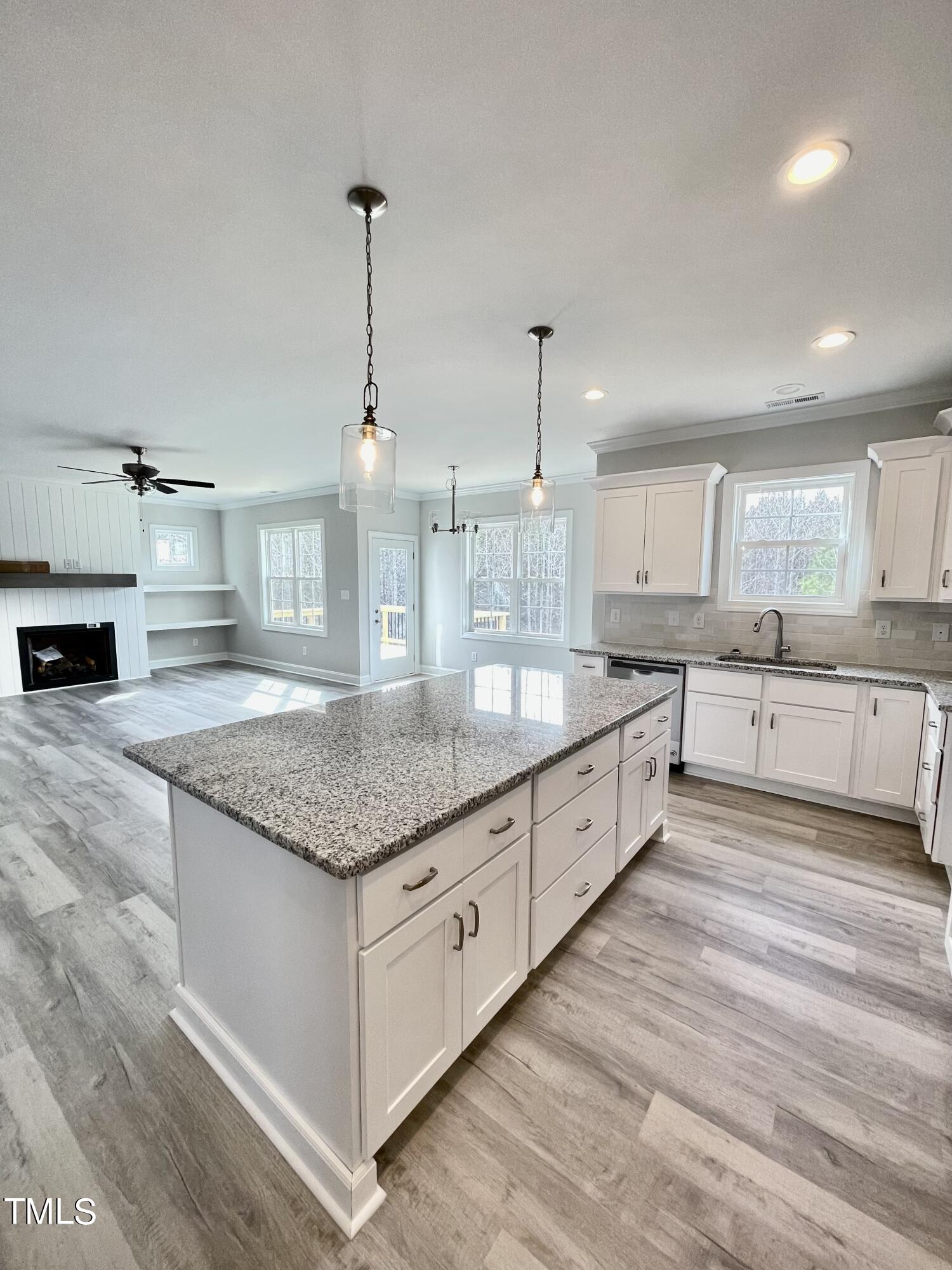 35 Sunrise Court Spring Hope, NC 27882 - Photo 17 of 18 a large kitchen with stainless steel appliances kitchen island granite countertop a large counter top a sink and a wooden floors