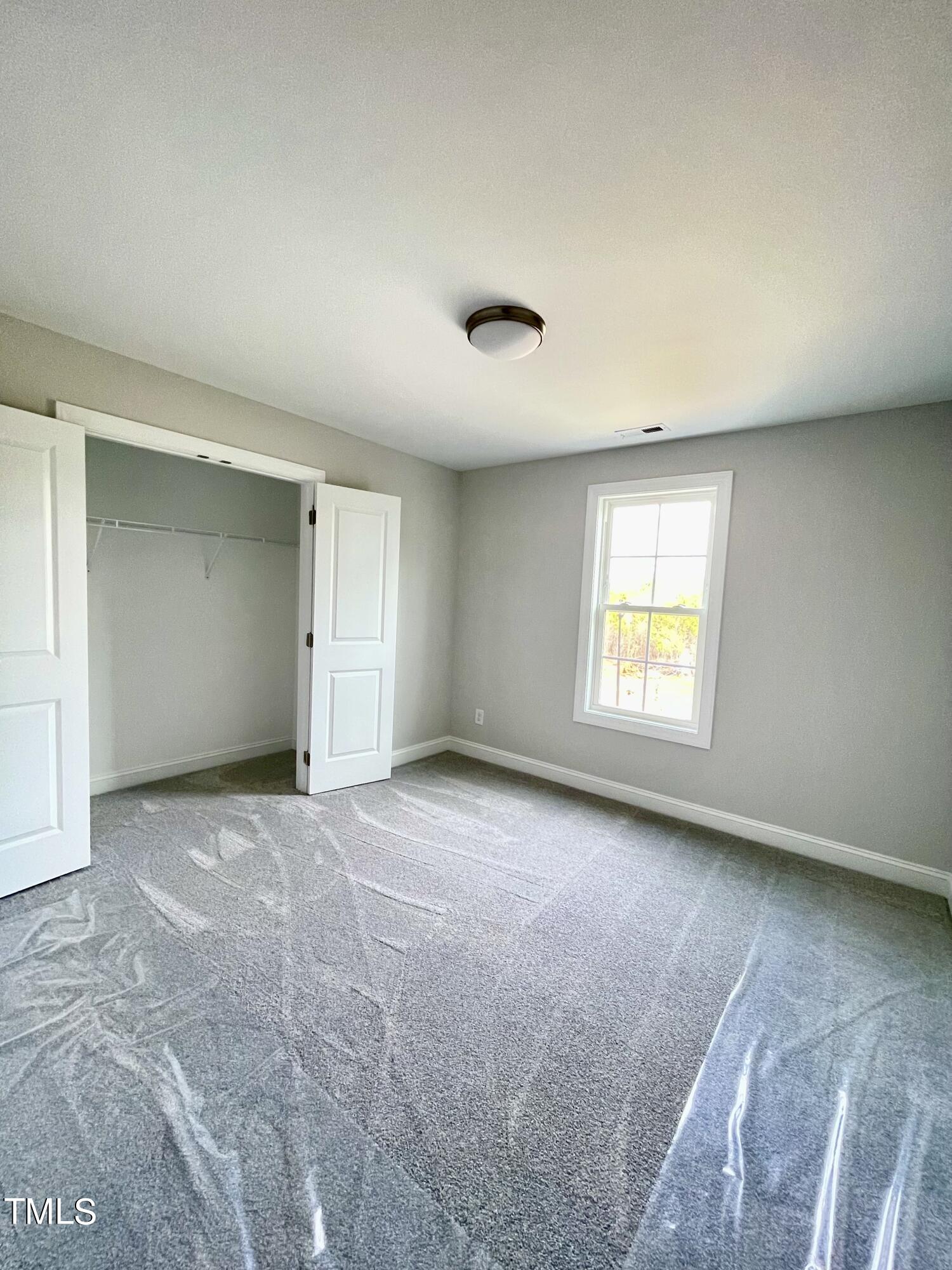 35 Sunrise Court Spring Hope, NC 27882 - Photo 18 of 18 an empty room with windows and closet