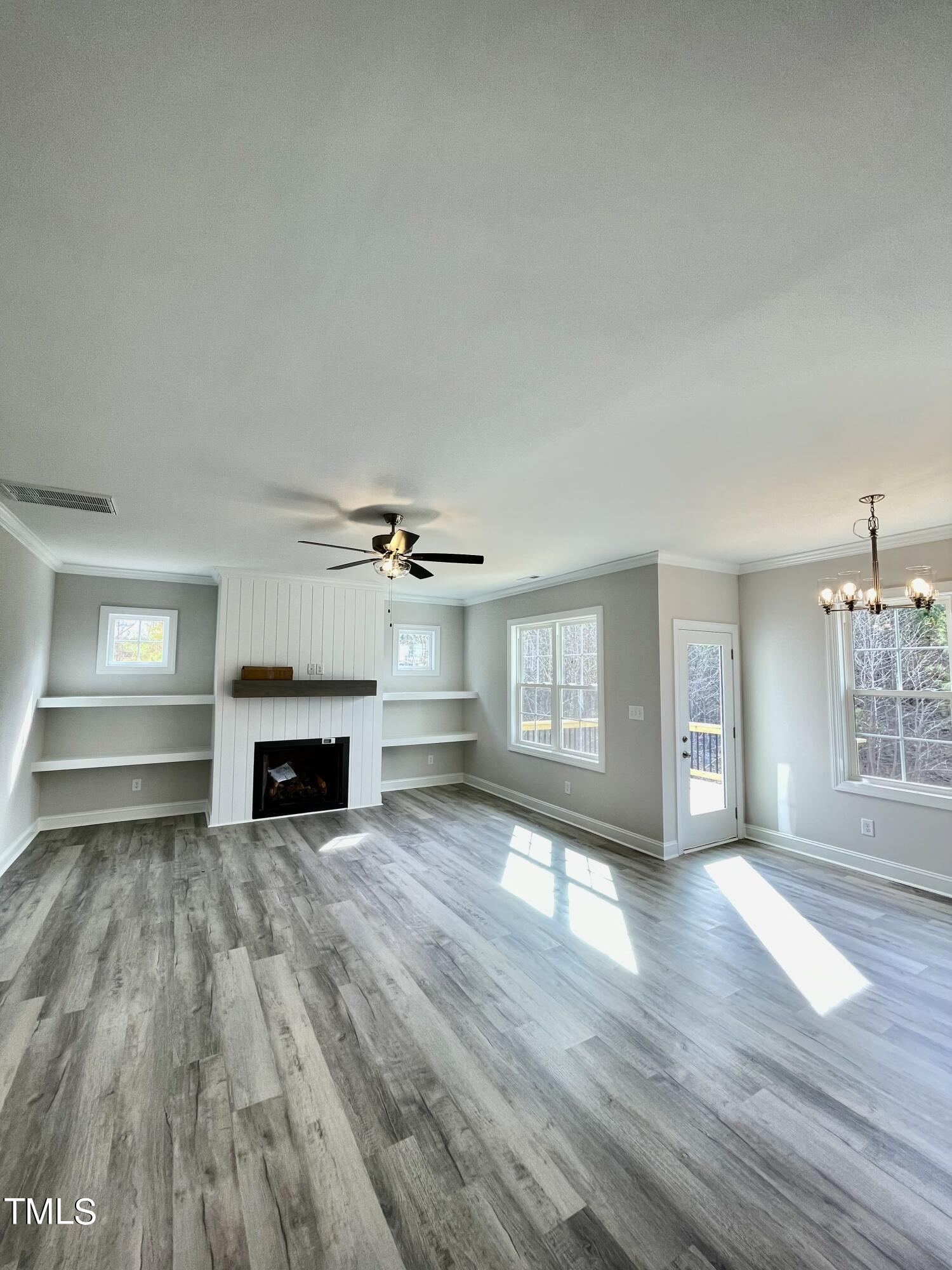 35 Sunrise Court Spring Hope, NC 27882 - Photo 6 of 18 a view of empty room with wooden floor and fireplace