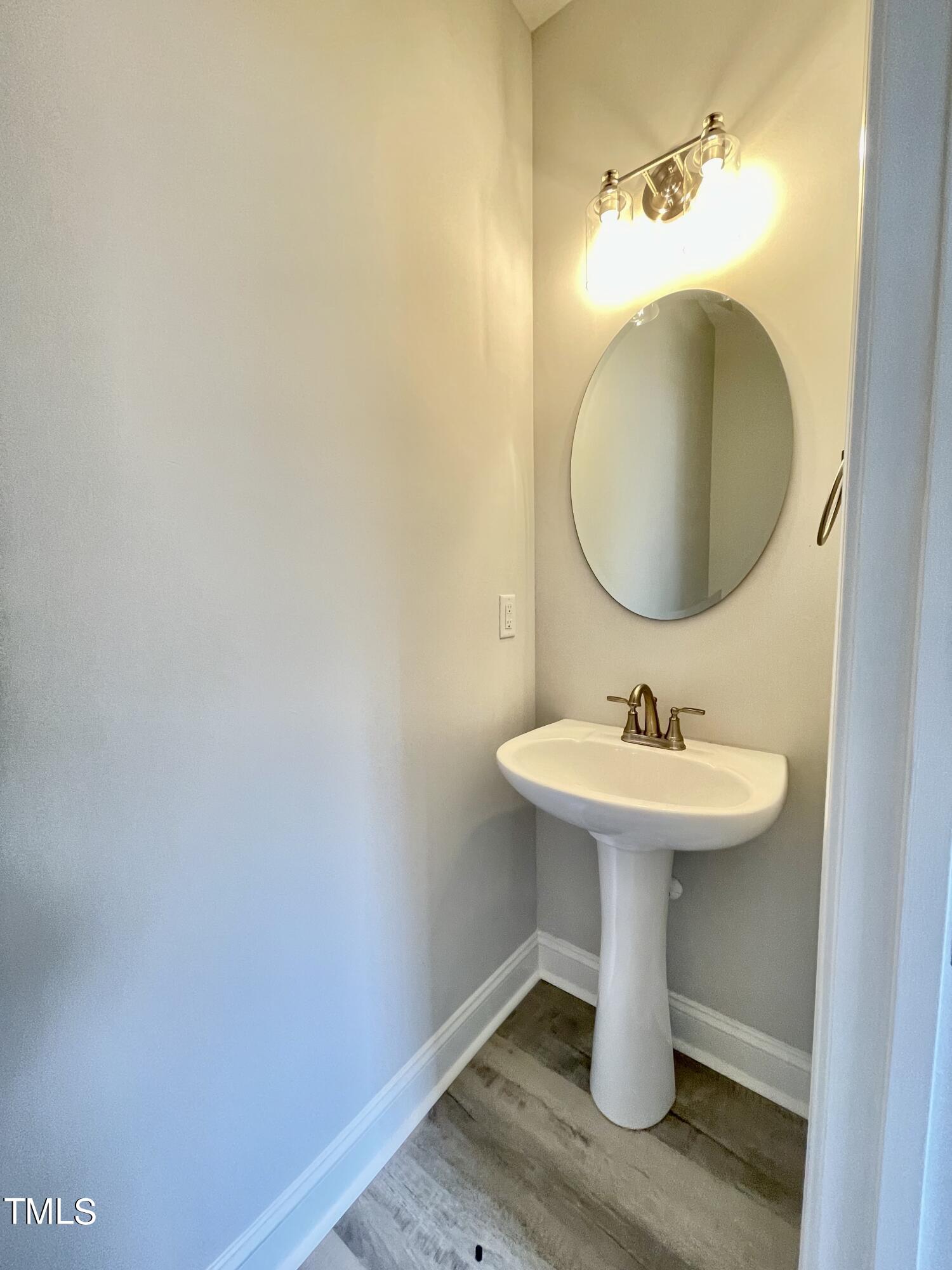 35 Sunrise Court Spring Hope, NC 27882 - Photo 7 of 18 a bathroom with a sink and mirror