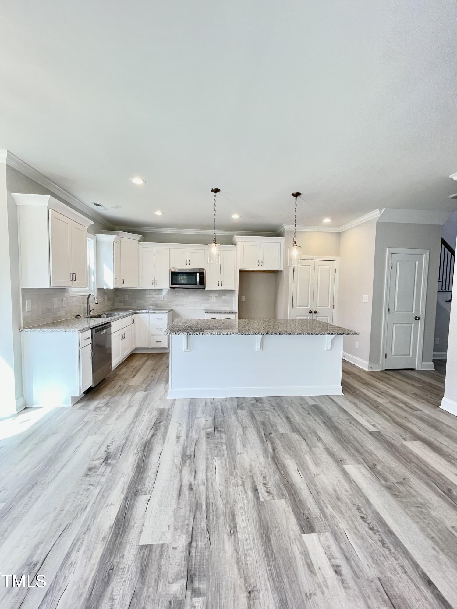 35 Sunrise Court Spring Hope, NC 27882 - Photo 8 of 18 a large kitchen with stainless steel appliances granite countertop a lot of cabinets and wooden floor