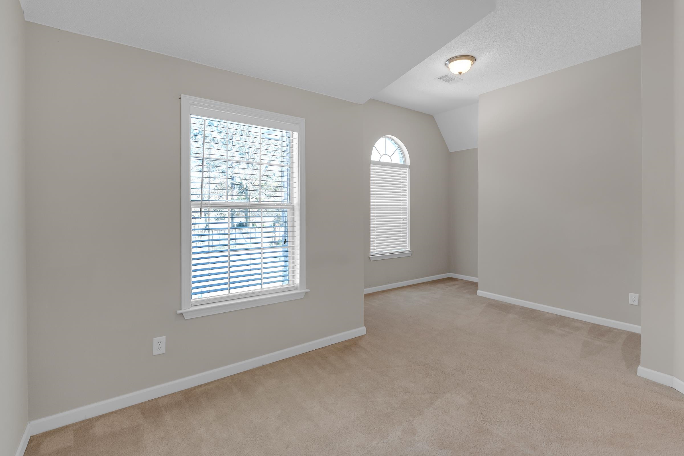 1229 North Sanga Road Memphis, TN 38016 - Photo 17 of 32 Unfurnished room with light carpet and lofted ceiling