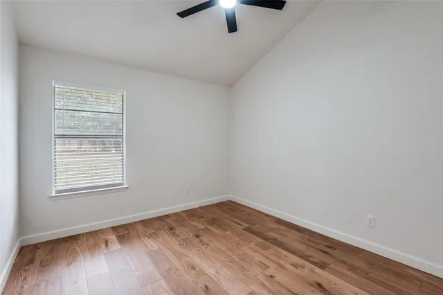 a kitchen with stainless steel appliances granite countertop a sink dishwasher a stove a refrigerator and dishwasher with wooden floor