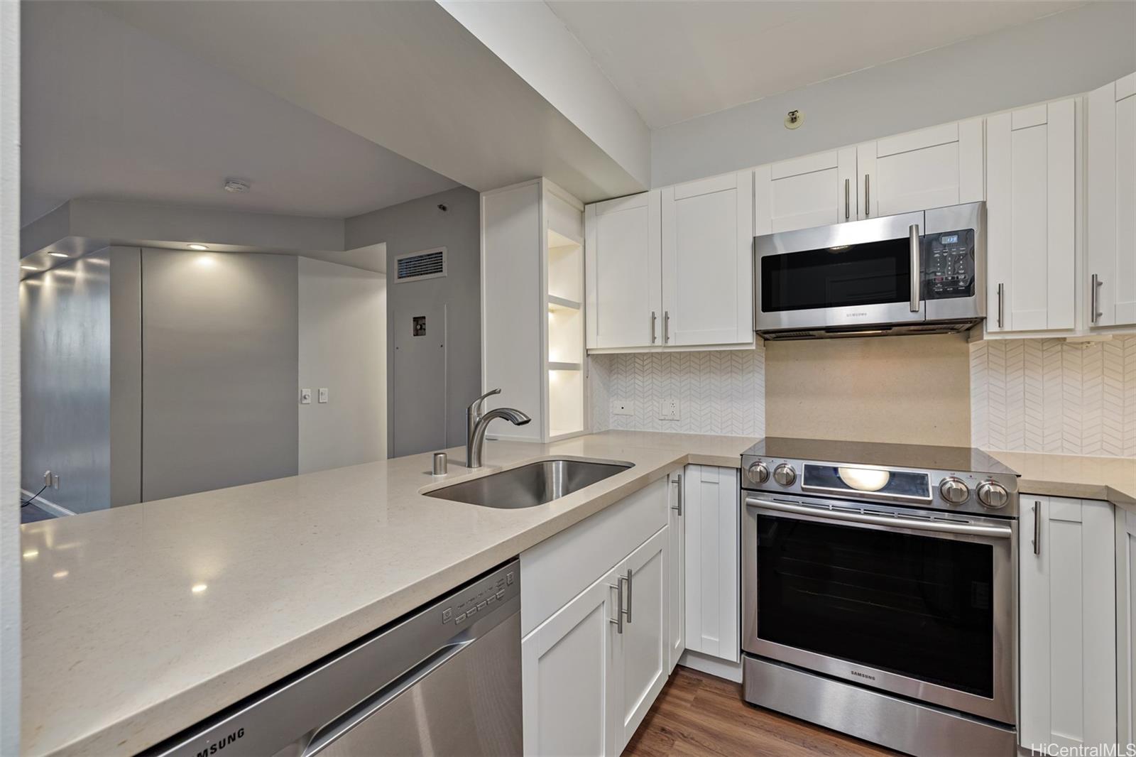 415 South Street, Unit 202 Honolulu, HI 96813 - Photo 1 of 1 a kitchen with stainless steel appliances a stove microwave and sink
