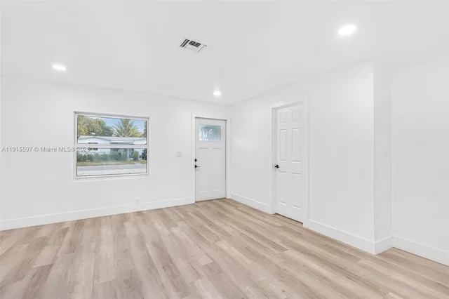 a view of an empty room with a window