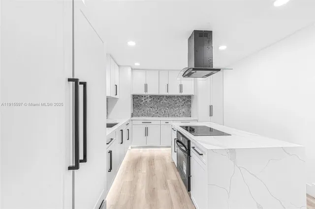 a kitchen with a sink stove and refrigerator