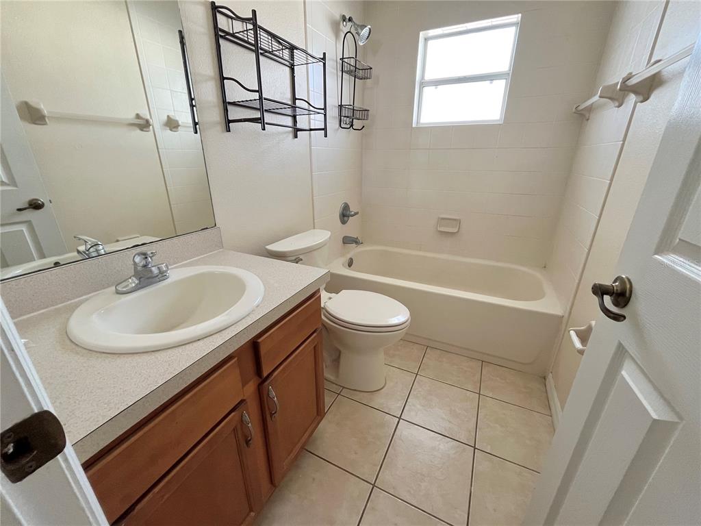 4420 Southwest 100th Street Ocala, FL 34476 - Photo 14 of 22 a bathroom with a sink a toilet and shower