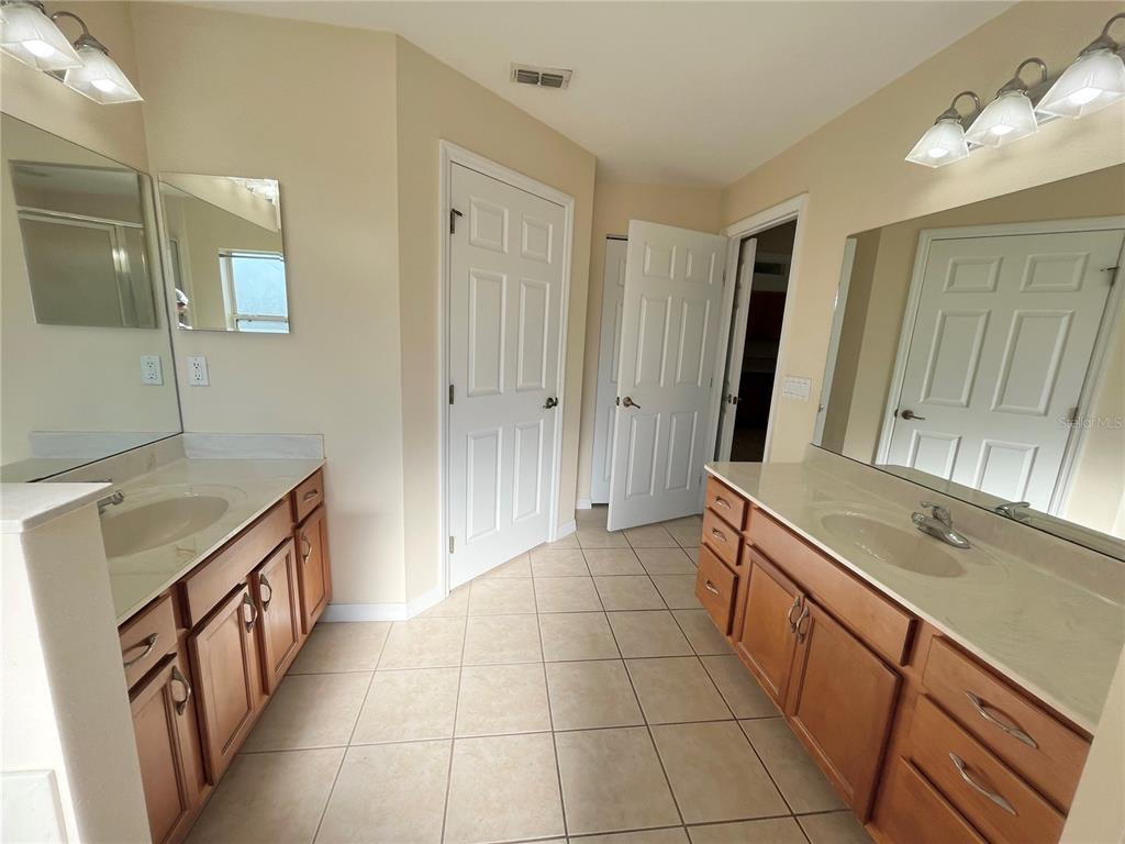 4420 Southwest 100th Street Ocala, FL 34476 - Photo 18 of 22 a bathroom with a sink a vanity and a mirror