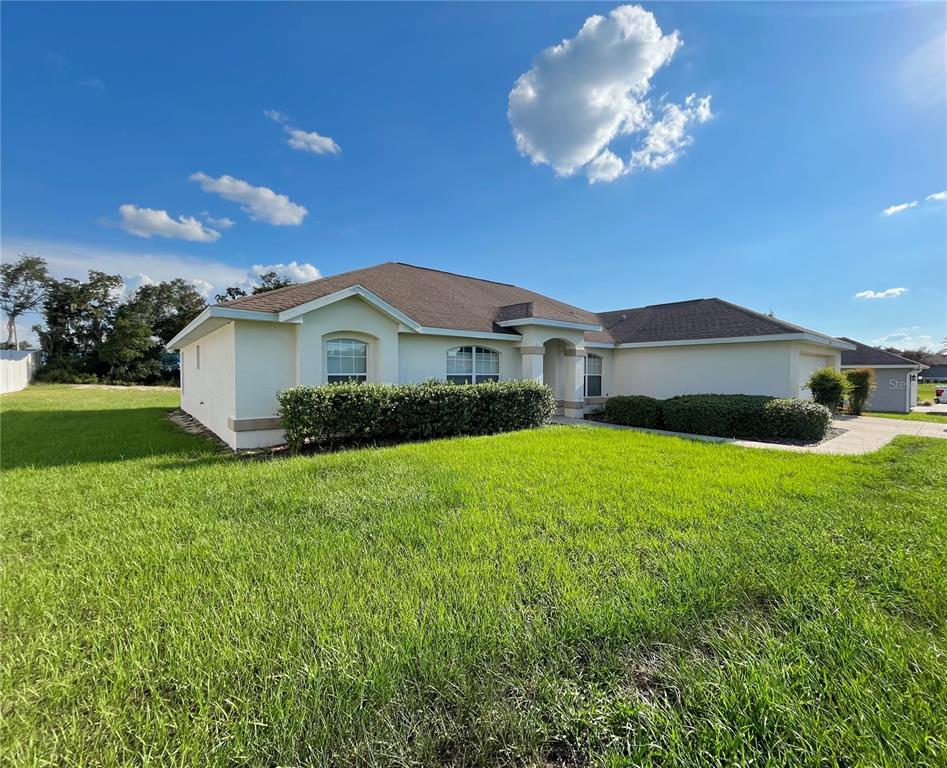 4420 Southwest 100th Street Ocala, FL 34476 - Photo 22 of 22 a front view of a house with garden