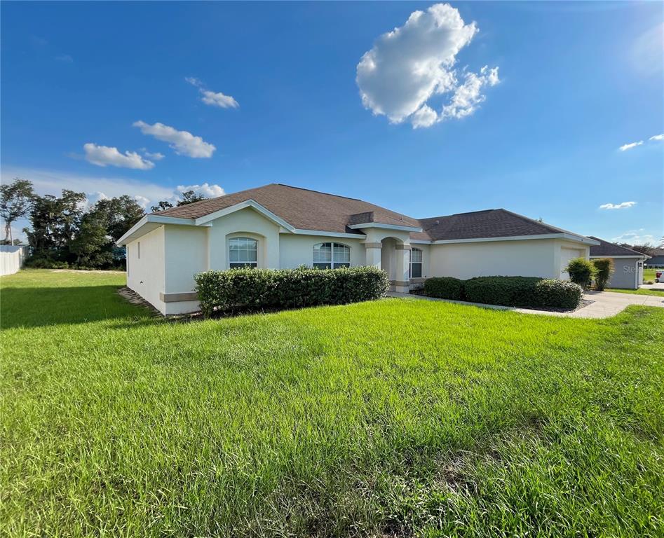 4420 Southwest 100th Street Ocala, FL 34476 - Photo 3 of 22 a front view of a house with garden