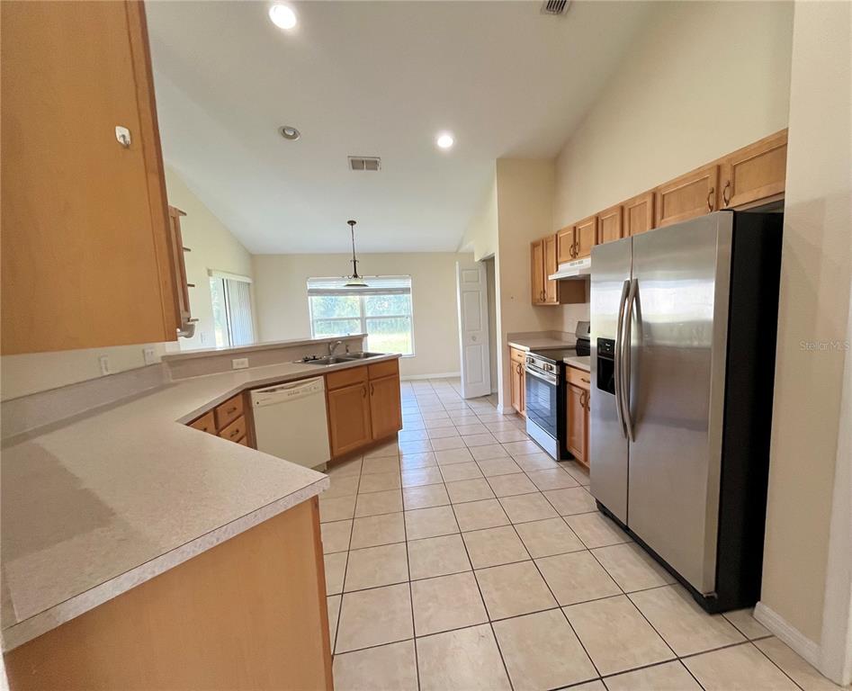 4420 Southwest 100th Street Ocala, FL 34476 - Photo 4 of 22 a kitchen with stainless steel appliances granite countertop a refrigerator and a sink