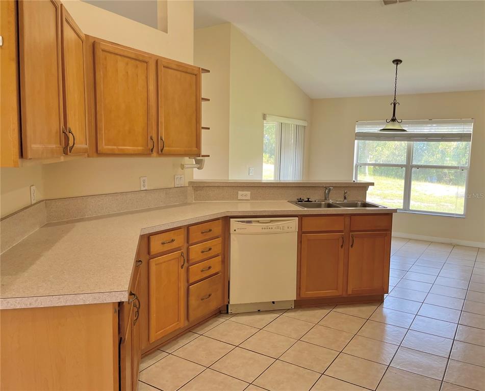 4420 Southwest 100th Street Ocala, FL 34476 - Photo 8 of 22 a kitchen with stainless steel appliances granite countertop a sink and a stove