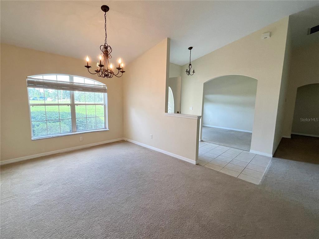 4420 Southwest 100th Street Ocala, FL 34476 - Photo 9 of 22 a view of a livingroom with a chandelier furniture and windows