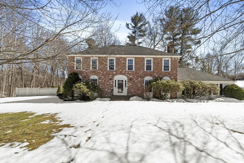 a front view of a house with a yard covered in snow
