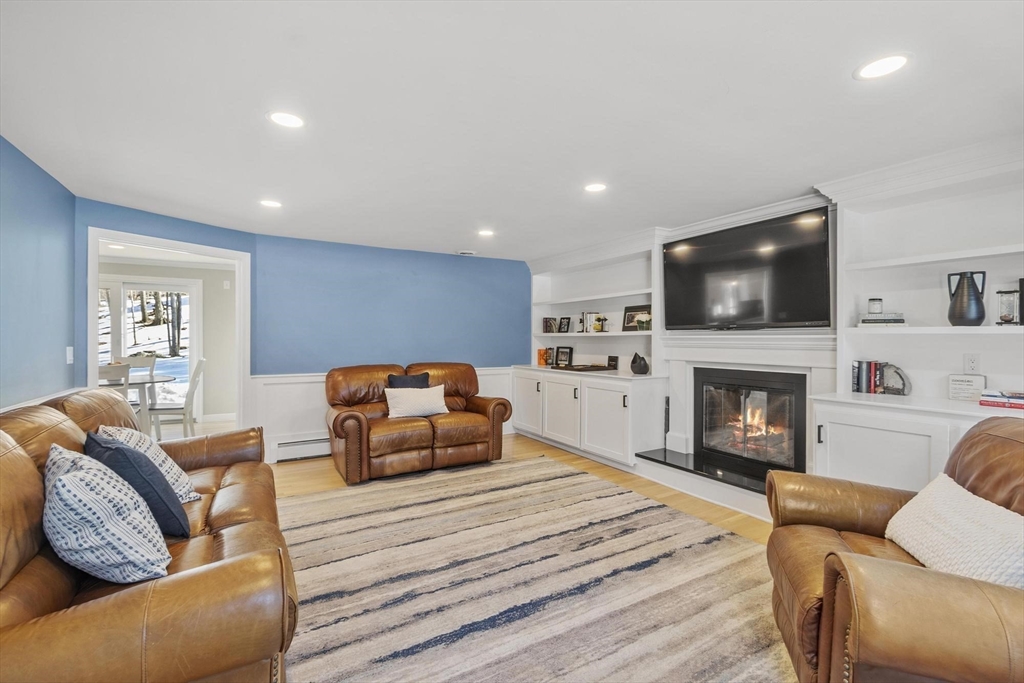 2 Greybirch Road Andover, MA 01810 - Photo 12 of 41 a living room with furniture a fireplace and a flat screen tv