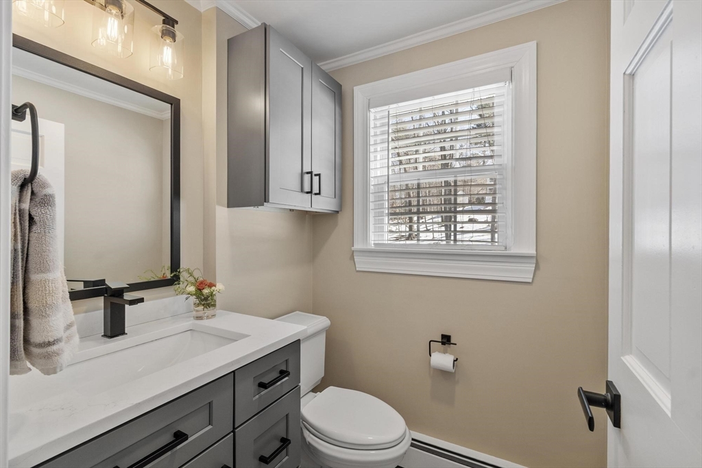 2 Greybirch Road Andover, MA 01810 - Photo 18 of 41 a bathroom with a granite countertop sink toilet a mirror and window