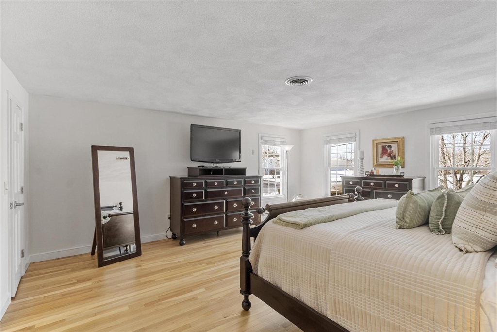 2 Greybirch Road Andover, MA 01810 - Photo 23 of 41 a bedroom with a bed and a flat screen tv