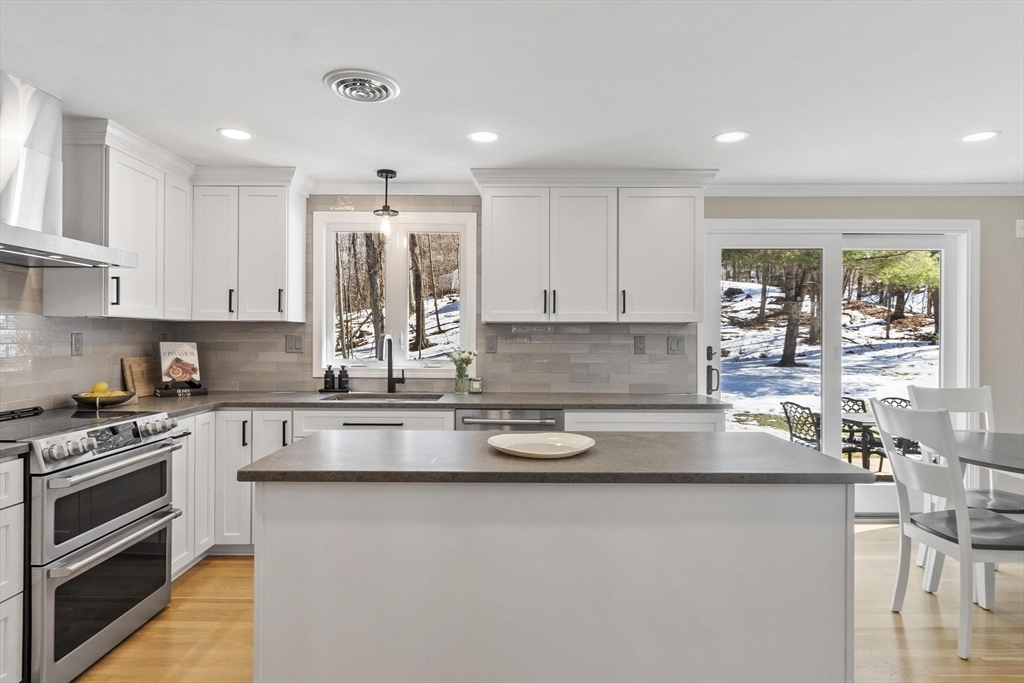 2 Greybirch Road Andover, MA 01810 - Photo 9 of 41 a kitchen with stainless steel appliances granite countertop a stove and white cabinets