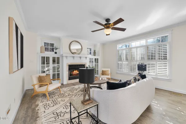 a living room with furniture a fireplace and a large window