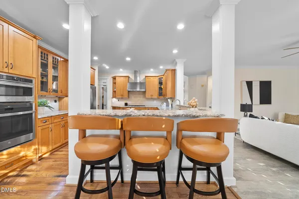 a kitchen with granite countertop stainless steel appliances granite countertop a sink dishwasher and cabinets with wooden floor