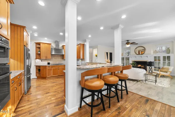 a large kitchen with stainless steel appliances granite countertop a sink and cabinets