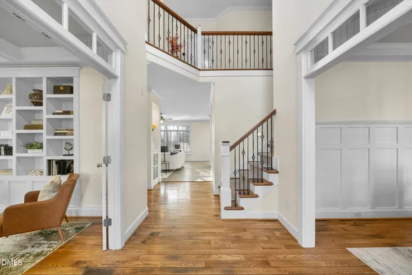 a living room with furniture and a painting on the wall