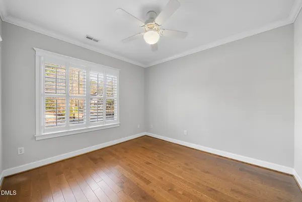 a bedroom with a bed a couch and a window