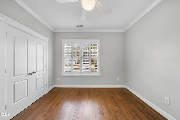 a large white kitchen with a large window and stainless steel appliances