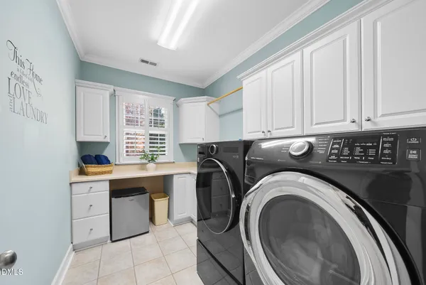 a kitchen with a sink and chandelier
