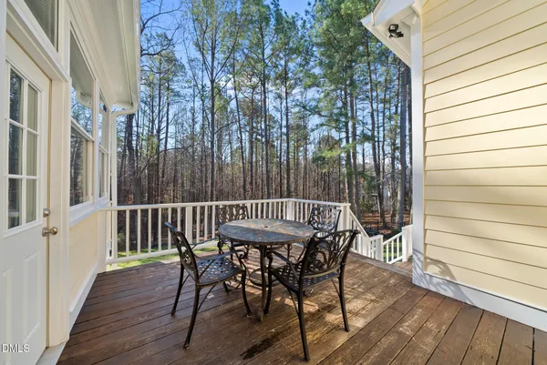 a view of a house with a small yard and a large tree
