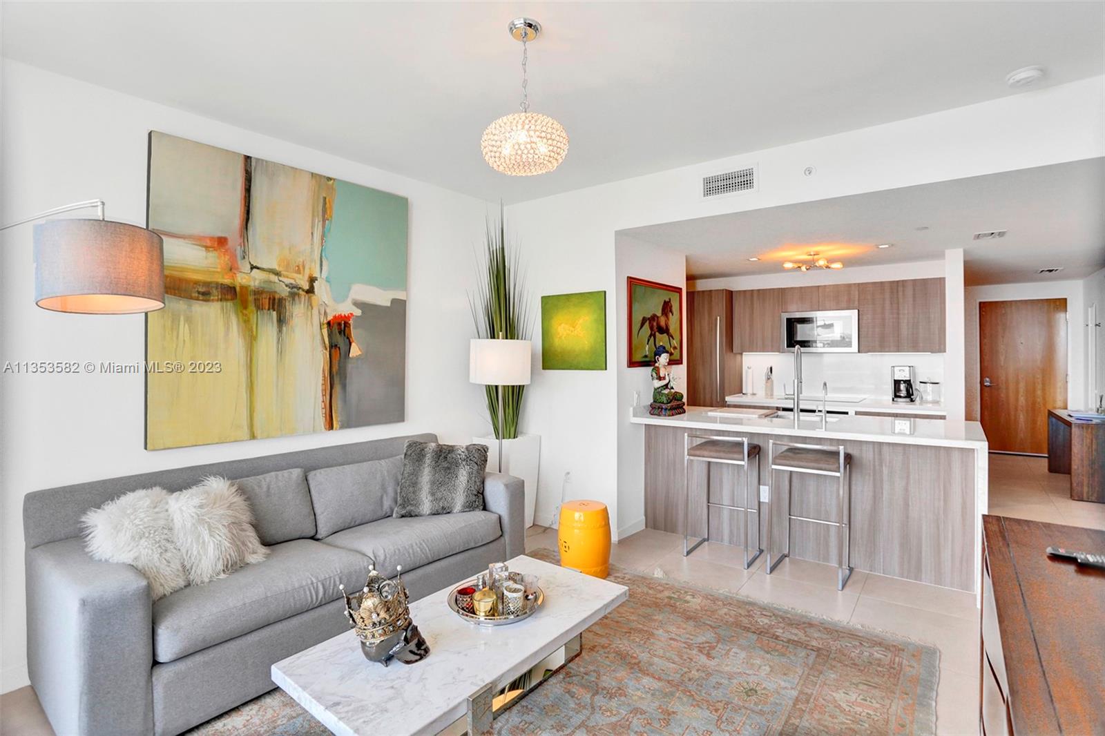 401 North Birch Road, Unit 903 Fort Lauderdale, FL 33304 - Photo 11 of 42 a living room with furniture kitchen view and a large window