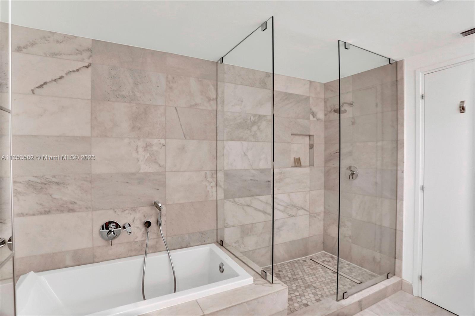 401 North Birch Road, Unit 903 Fort Lauderdale, FL 33304 - Photo 12 of 42 a bathroom with a bathtub and a shower