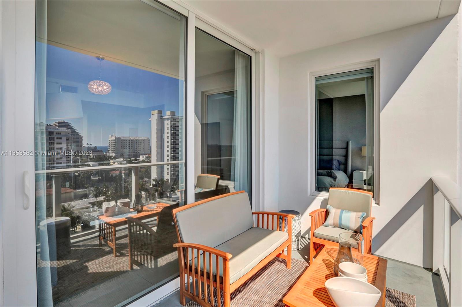 401 North Birch Road, Unit 903 Fort Lauderdale, FL 33304 - Photo 21 of 42 view of living room with patio furniture and floor to ceiling window